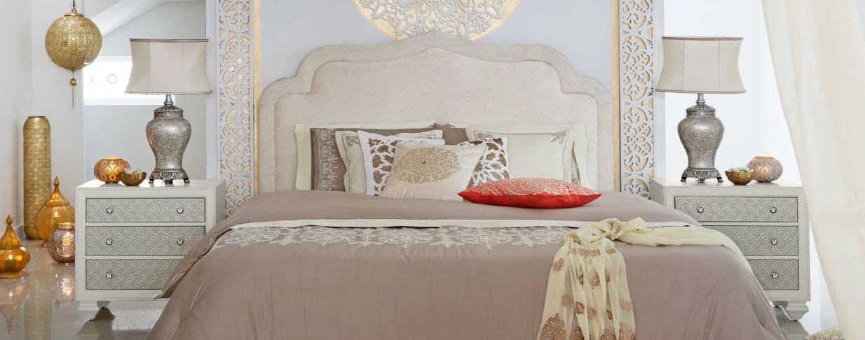 A modern Arabic bedroom featuring a king size bed and two night stands.